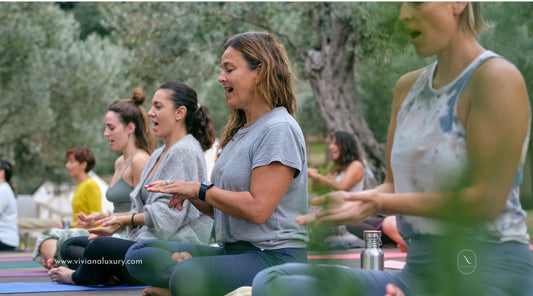 Image of women meditating, practicing yoga outdoors in nature