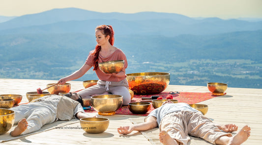 Image of woman outdoors leading an inspiring sound bath with candles