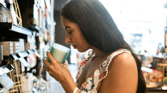 Smelling a natural soy candle for calming wellness ritual at home