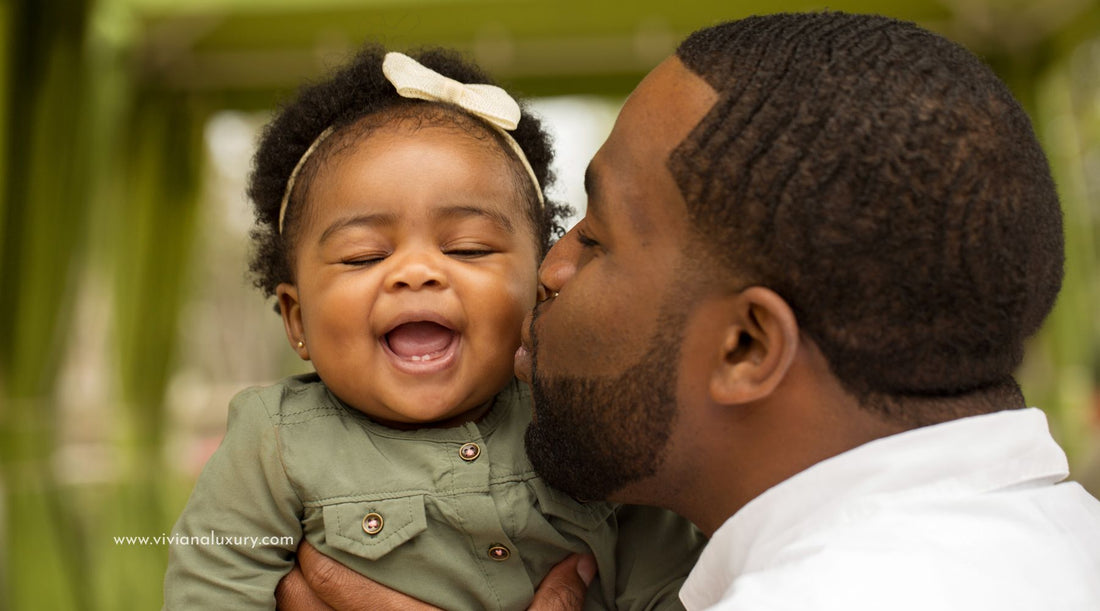 Image of father kissing his daughter