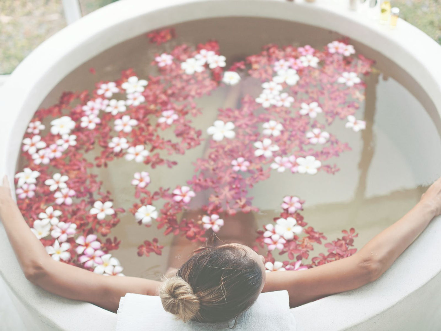 Hibiscus flower candle and bath with beautiful woman relaxing.